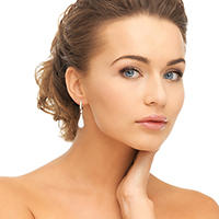 beautiful woman in white dress and diamond earrings
