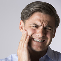 Man in apparent jaw pain