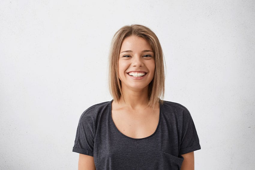Benefits-of-Cosmetic-Dentistry-When-No-one-Can-See-Your-Smile woman shows off her her cute smile